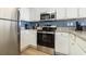 Kitchen features stainless steel appliances, granite countertops, and white cabinets at 2701 S Ocean Blvd. # 1908, North Myrtle Beach, SC 29582