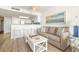 Bright living room featuring a comfortable sofa, accent chair, and access to the kitchenette at 2701 S Ocean Blvd. # 1908, North Myrtle Beach, SC 29582