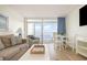 Bright living room with dining area and balcony access offering beautiful ocean views at 2701 S Ocean Blvd. # 1908, North Myrtle Beach, SC 29582
