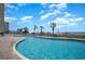 Large outdoor pool with lounge chairs and palm trees by the ocean at 2701 S Ocean Blvd. # 1908, North Myrtle Beach, SC 29582