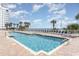 Outdoor pool with plentiful lounge chairs, brick patio, and a view of palm trees and the beach at 2701 S Ocean Blvd. # 1908, North Myrtle Beach, SC 29582