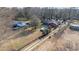 Aerial view of a home with two structures, a pool, and a long driveway through the wooded country landscape at 2945 Old Railroad Rd., Conway, SC 29527