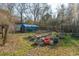 Expansive backyard featuring a garden, greenhouse, and lush greenery, ideal for outdoor activities at 2945 Old Railroad Rd., Conway, SC 29527