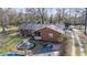 Exterior of a brick home, showcasing the front entrance, mature landscaping, and a unique water feature at 2945 Old Railroad Rd., Conway, SC 29527