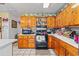 The kitchen has wood cabinets, an oven, and tiled flooring for a functional cooking space at 2945 Old Railroad Rd., Conway, SC 29527