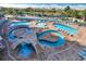 Aerial view of winding pools with lounge seating, fountains, landscaping, and a walkable deck at 300 N Ocean Blvd. # 1026, North Myrtle Beach, SC 29582