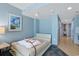 Minimalist bedroom with a bed and decor, leading to a view of the kitchen area at 300 N Ocean Blvd. # 1026, North Myrtle Beach, SC 29582