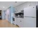 Compact, efficient kitchen with white appliances and countertops, maximizing space at 300 N Ocean Blvd. # 1026, North Myrtle Beach, SC 29582