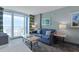 Comfortable living room with a sofa, coffee table, lamps, artwork and view to a balcony at 300 N Ocean Blvd. # 1026, North Myrtle Beach, SC 29582