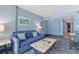 Living room showcases a sofa, side tables, and artwork in a soothing color palette at 300 N Ocean Blvd. # 1026, North Myrtle Beach, SC 29582