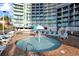 Outdoor resort pool area with water feature, lounge seating, and views of resort at 300 N Ocean Blvd. # 1026, North Myrtle Beach, SC 29582