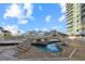 Outdoor resort pool area featuring a decorative bridge, lounge seating, and blue skies at 300 N Ocean Blvd. # 1026, North Myrtle Beach, SC 29582