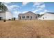 View of a well-maintained backyard, surrounded by neighboring houses in a serene setting at 310 Junco Circle, Longs, SC 29568