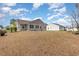 Large backyard, perfect for Gathering activities, with house and patio visible at 310 Junco Circle, Longs, SC 29568