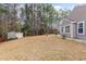 Large, grassy backyard with mature trees and a storage shed on the property at 310 Junco Circle, Longs, SC 29568