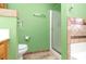 This bathroom features a toilet, shower, and vanity with decorative tilework at 310 Junco Circle, Longs, SC 29568