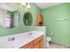 Bathroom featuring double vanity sinks, mirrors, a toilet, and a cabinet for toiletries at 310 Junco Circle, Longs, SC 29568