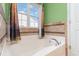 View of a deep bathtub with decorative tilework, and a window showing a glimpse of the exterior at 310 Junco Circle, Longs, SC 29568