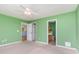 Bedroom featuring green walls, ceiling fan, doorway leading to the kitchen and a full bath at 310 Junco Circle, Longs, SC 29568