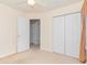 Bedroom featuring neutral walls, doorway leading to a full bath and closets at 310 Junco Circle, Longs, SC 29568