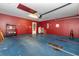 Spacious two car garage with blue flooring, red walls, and ample storage at 310 Junco Circle, Longs, SC 29568