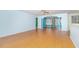 Open living area with hardwood floors and access to a sunroom through an archway at 310 Junco Circle, Longs, SC 29568