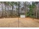 Backyard storage shed surrounded by tall trees providing shade and privacy at 310 Junco Circle, Longs, SC 29568