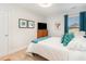 A cozy bedroom features a queen-sized bed and a window with vibrant teal curtains for a bright touch at 378 Dunbarton Ln., Conway, SC 29526