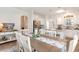 Bright dining area featuring a wooden table, seating for six, and an open concept to kitchen at 378 Dunbarton Ln., Conway, SC 29526