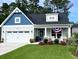 Charming two-story home with a blue accent and manicured lawn offers inviting curb appeal at 378 Dunbarton Ln., Conway, SC 29526
