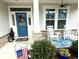 Inviting entryway with white rocking chairs on a covered porch, a ceiling fan and blue decor at 378 Dunbarton Ln., Conway, SC 29526
