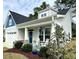 Inviting covered front porch with white rocking chairs and well-manicured landscaping at 378 Dunbarton Ln., Conway, SC 29526