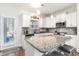 Modern kitchen with stainless steel appliances, granite countertops and an island with bar seating at 378 Dunbarton Ln., Conway, SC 29526