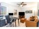 A modern home office with a desk, sofa, ceiling fan, and natural light provides a comfortable workspace at 378 Dunbarton Ln., Conway, SC 29526
