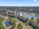 Scenic aerial view of condo community featuring a pool, tennis court, lake and manicured landscaping at 380 Myrtle Greens Dr. # E, Conway, SC 29526
