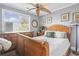 Comfortable bedroom featuring a decorative ceiling fan, hardwood floors, lots of natural light, and traditional decor at 380 Myrtle Greens Dr. # E, Conway, SC 29526