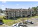 Exterior of an apartment building with multiple floors, balconies, and parking spaces at 380 Myrtle Greens Dr. # E, Conway, SC 29526