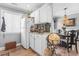 Bright kitchen features white cabinets and a view to the dining area with hanging chandelier at 380 Myrtle Greens Dr. # E, Conway, SC 29526