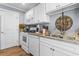 Bright kitchen featuring white cabinets, granite countertops, stainless steel appliances, and hardwood floors at 380 Myrtle Greens Dr. # E, Conway, SC 29526