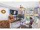 Cozy living room featuring a piano, comfortable seating, hardwood floors, and a sliding glass door to the outside at 380 Myrtle Greens Dr. # E, Conway, SC 29526