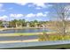 Scenic view of a pond surrounded by lush trees and neighborhood homes at 380 Myrtle Greens Dr. # E, Conway, SC 29526