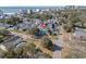 An aerial view showcases a charming neighborhood with colorful homes and lush trees with the ocean in the background at 3901-B Birchwood St., North Myrtle Beach, SC 29582