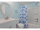 Charming bathroom with a vanity, toilet, and a shower/tub featuring a fun, patterned curtain at 3901-B Birchwood St., North Myrtle Beach, SC 29582