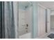 Bright bathroom features a shower/tub with a modern showerhead and a blue shower curtain at 3901-B Birchwood St., North Myrtle Beach, SC 29582