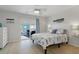 Comfortable bedroom featuring light wood floors, ceiling fan, and sliding glass door to the outdoor deck at 3901-B Birchwood St., North Myrtle Beach, SC 29582