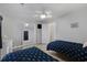 Light-filled bedroom with two beds, ceiling fan, and access to a closet and bathroom at 3901-B Birchwood St., North Myrtle Beach, SC 29582