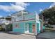 Charming two-story exterior featuring a covered porch, balcony, blue siding, and colorful front door and window at 3901-B Birchwood St., North Myrtle Beach, SC 29582
