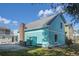 The home's exterior features a charming blue and white color scheme with a brick chimney and convenient outdoor shower at 3901-B Birchwood St., North Myrtle Beach, SC 29582