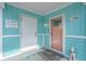 Inviting front porch with a 'beach happy' sign and a charming welcome mat at 3901-B Birchwood St., North Myrtle Beach, SC 29582