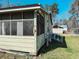 View of the screened-in porch with an access ramp and a detached garage at 422 S Magnolia Ave., Andrews, SC 29510
